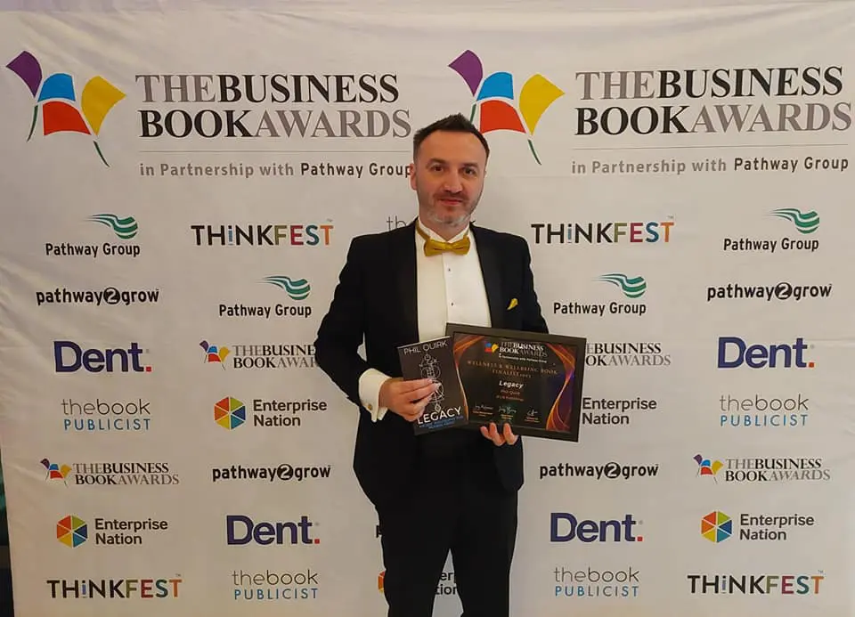 a man in a suit holding a plaque