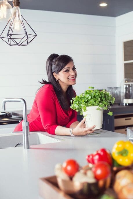 a woman holding a potted plant
