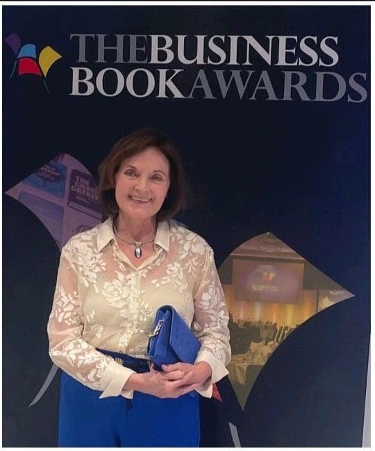 a woman standing in front of a sign