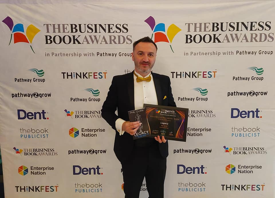 a man in a suit holding a plaque